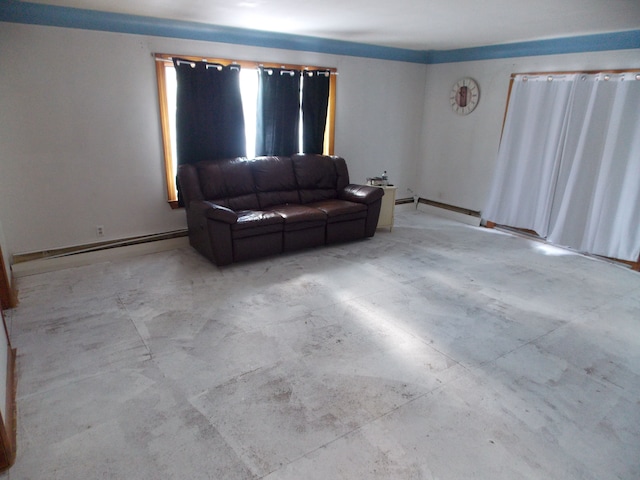 living area with baseboard heating, a baseboard radiator, and concrete flooring