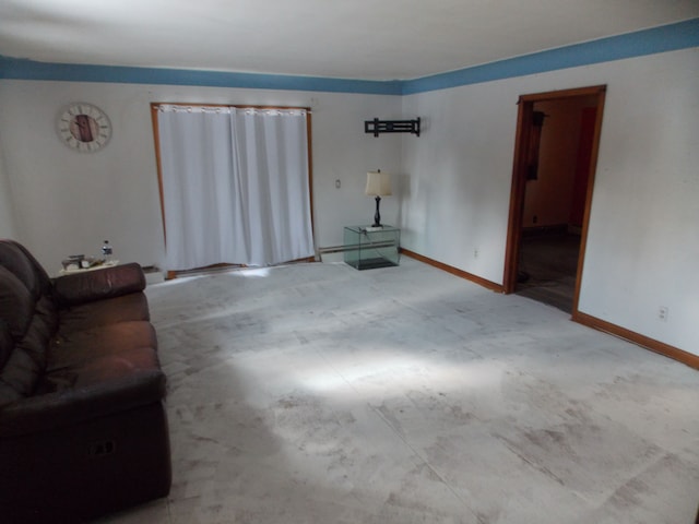 unfurnished living room featuring baseboard heating and baseboards
