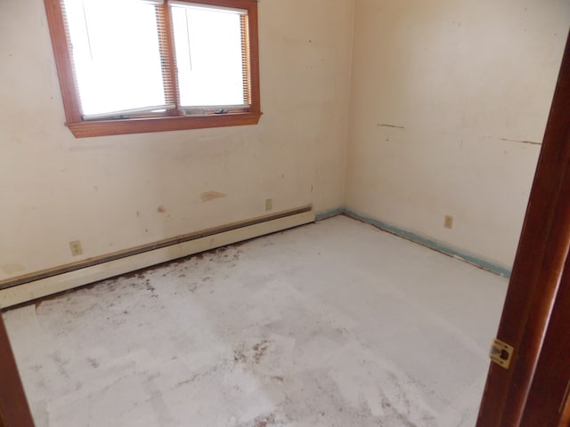 unfurnished room featuring a baseboard heating unit