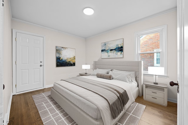 bedroom with hardwood / wood-style flooring and ornamental molding