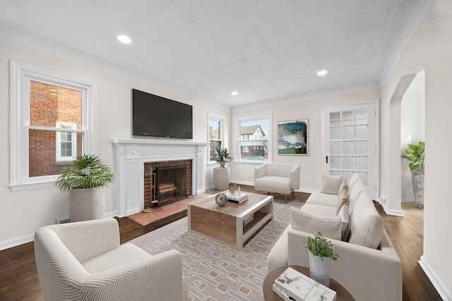 living room featuring a textured ceiling and dark hardwood / wood-style flooring