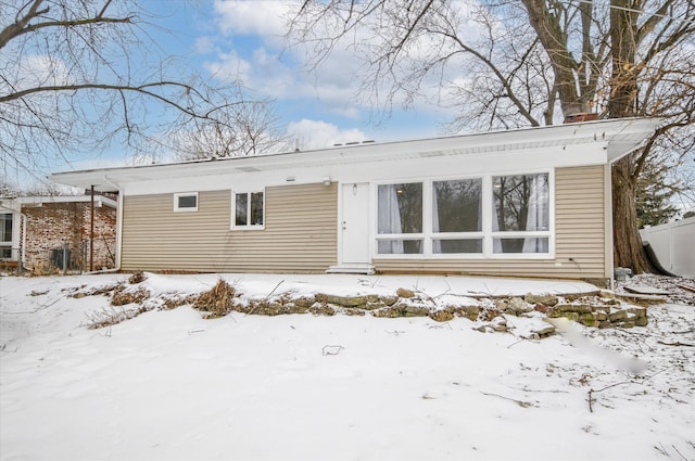 view of snow covered back of property