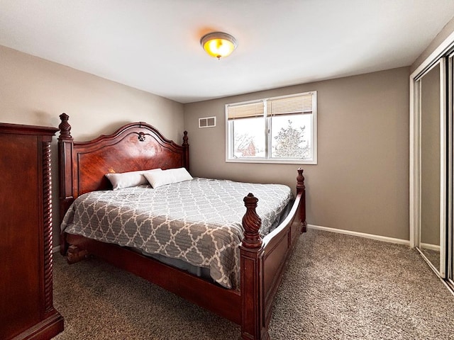 bedroom featuring dark carpet and a closet