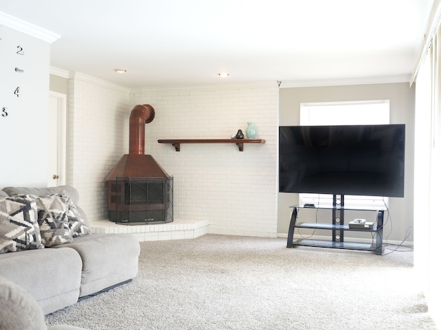 living room with a wood stove, carpet, crown molding, and brick wall