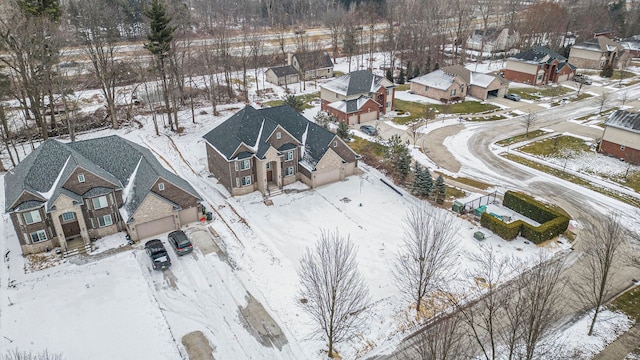 snowy aerial view with a residential view