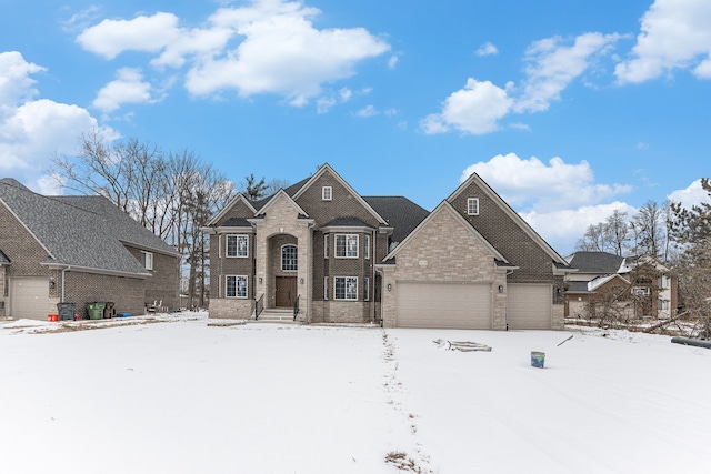 view of front of home with a garage and brick siding