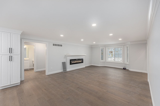 unfurnished living room featuring hardwood / wood-style flooring and ornamental molding