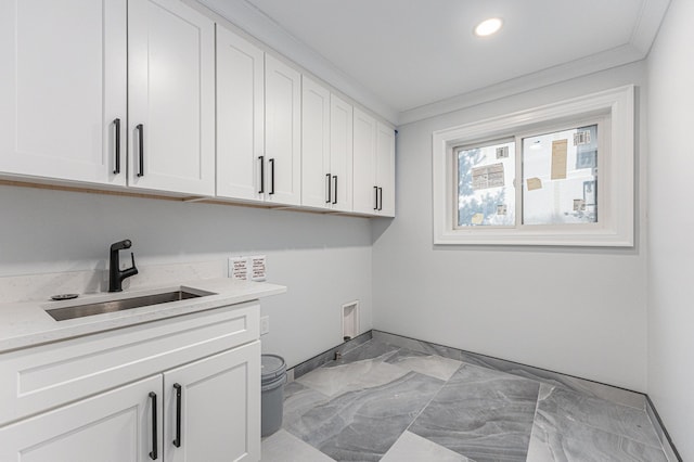 laundry area with washer hookup, sink, ornamental molding, and cabinets