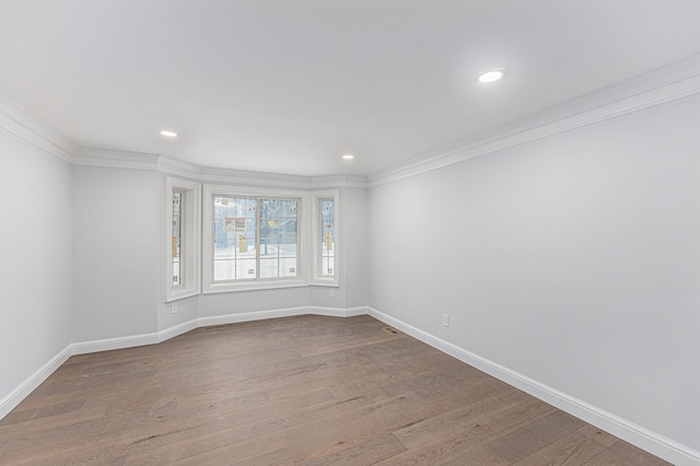 unfurnished room featuring hardwood / wood-style flooring and ornamental molding