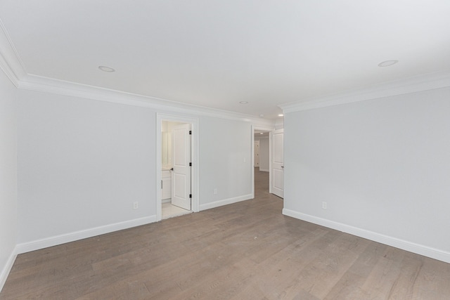 empty room featuring ornamental molding and light wood-type flooring