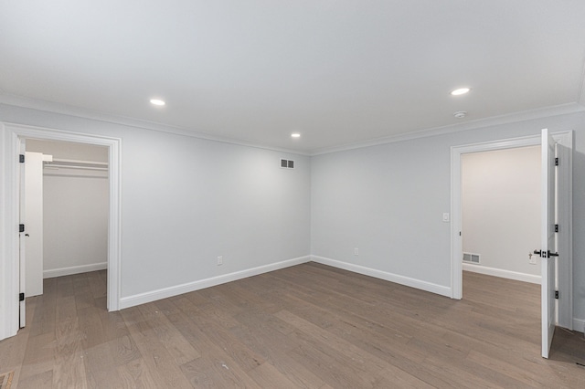 interior space with ornamental molding and light wood-type flooring