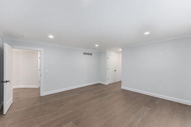 spare room featuring visible vents, wood finished floors, ornamental molding, and recessed lighting