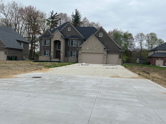 traditional-style house with brick siding, driveway, and a garage