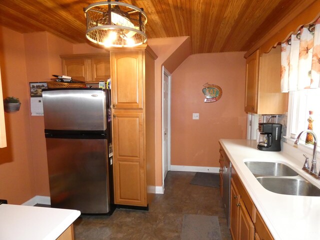 kitchen featuring a sink, freestanding refrigerator, light countertops, and wooden ceiling