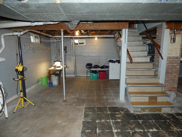 basement featuring washing machine and dryer and stairs