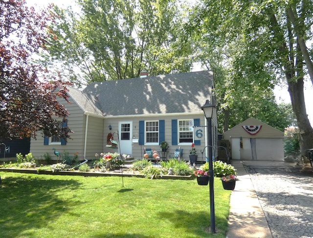 6 Poplar St, Three Oaks, MI 49128 - view of front of house featuring a garage, an outdoor structure, a front lawn, a chimney, and roof with shingles