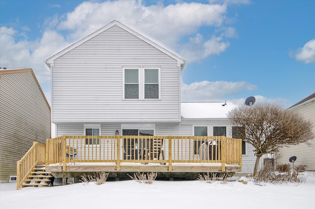 snow covered property with a wooden deck