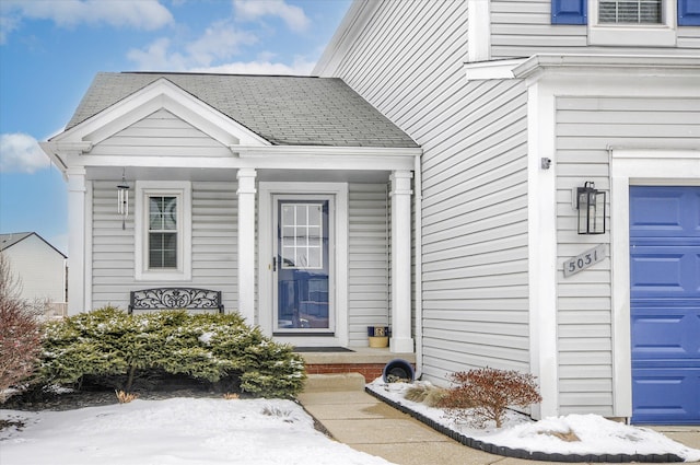 view of snow covered property entrance