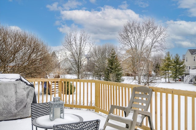 snow covered deck featuring grilling area