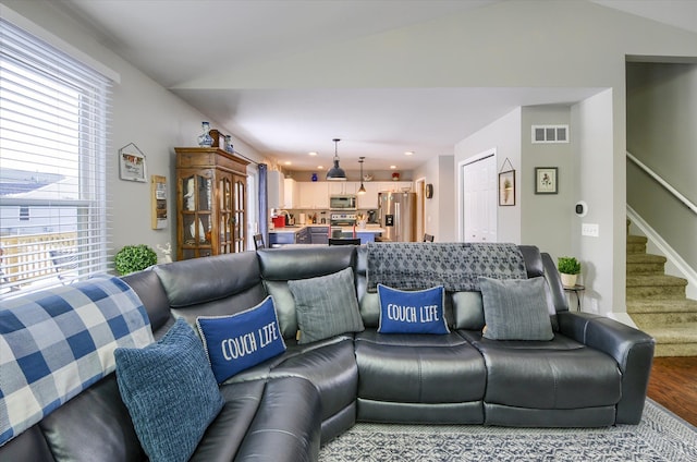 living room with hardwood / wood-style flooring and vaulted ceiling