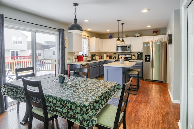 dining space with dark hardwood / wood-style flooring and sink