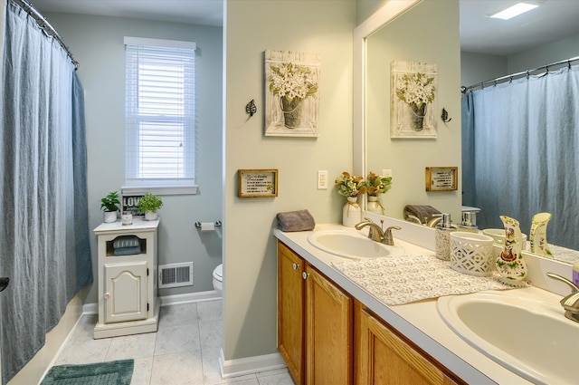 bathroom with tile patterned flooring, vanity, curtained shower, and toilet