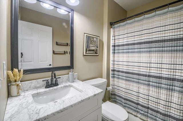 bathroom featuring vanity, curtained shower, and toilet