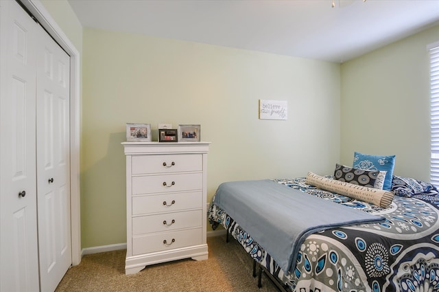 bedroom featuring light carpet and a closet