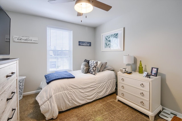 bedroom featuring ceiling fan and dark colored carpet