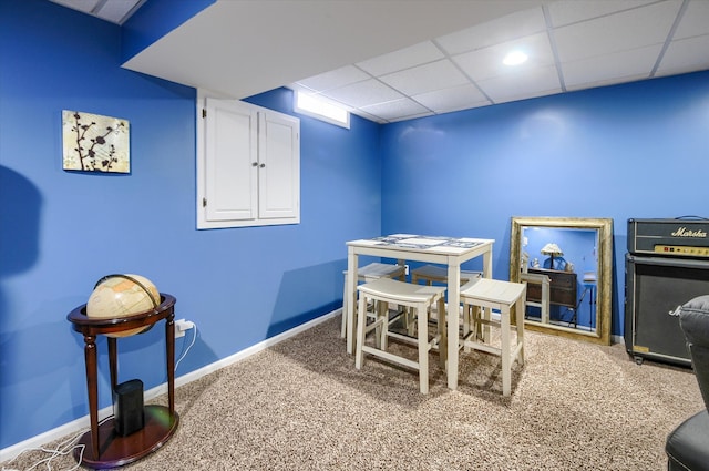 playroom with carpet floors and a paneled ceiling