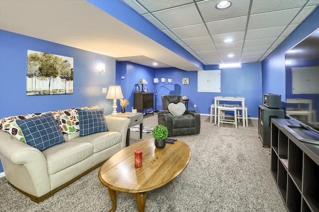 carpeted living room with a paneled ceiling