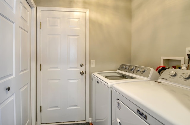 laundry area featuring washing machine and clothes dryer