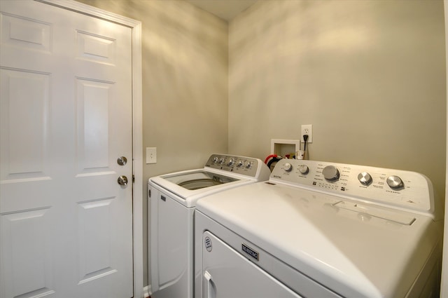 laundry area with washing machine and clothes dryer