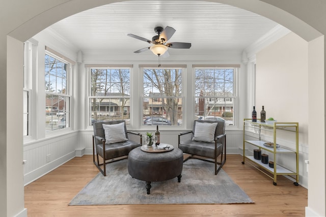 sitting room with a wealth of natural light, light hardwood / wood-style flooring, and ornamental molding