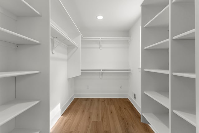 spacious closet with hardwood / wood-style floors