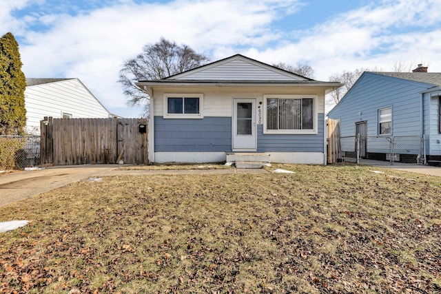 bungalow-style home with a front lawn