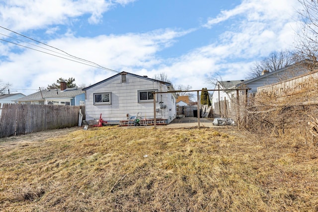 rear view of house featuring a yard and a patio