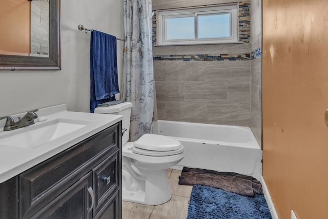 full bathroom with vanity, shower / tub combo with curtain, and toilet