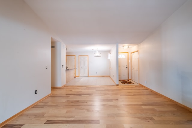 hallway with light hardwood / wood-style flooring