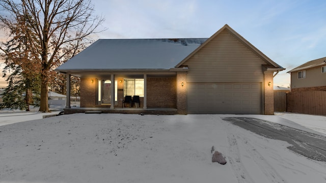 view of front of home with a porch and a garage