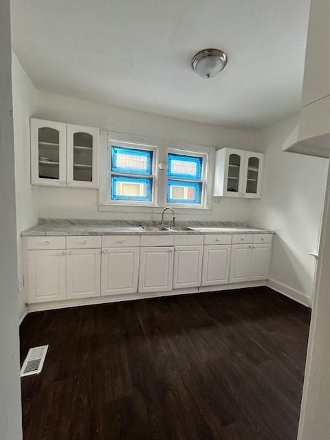 kitchen with sink, white cabinets, and dark hardwood / wood-style floors