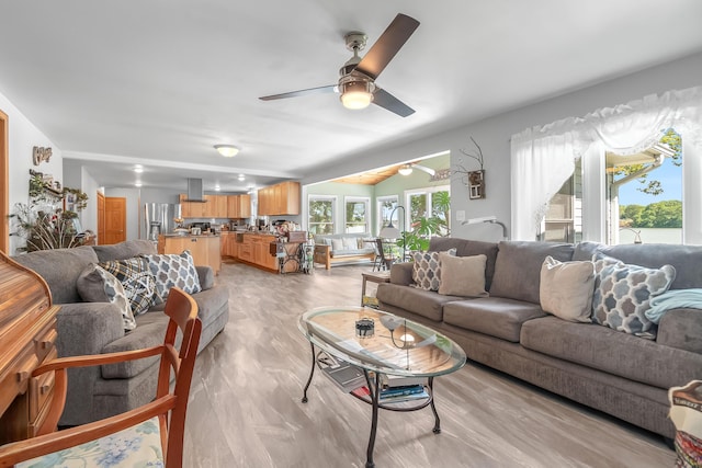 living room featuring ceiling fan and light hardwood / wood-style flooring