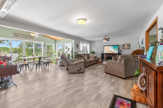 living room with ceiling fan and light wood-type flooring