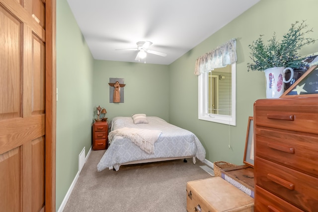 bedroom featuring ceiling fan and carpet