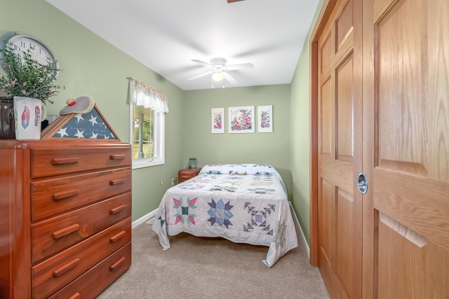 bedroom featuring light carpet and ceiling fan