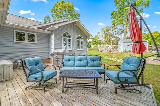 wooden deck with a shed, an outdoor living space, and a lawn