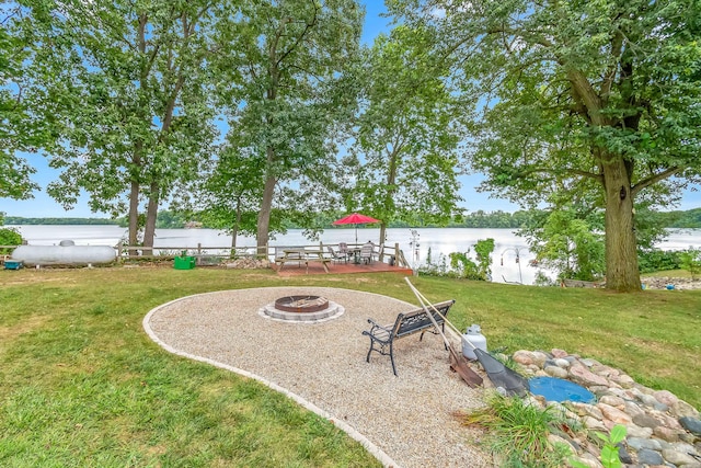 view of yard featuring a fire pit and a water view