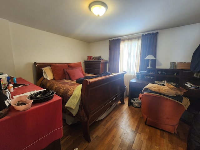 bedroom with dark wood-type flooring
