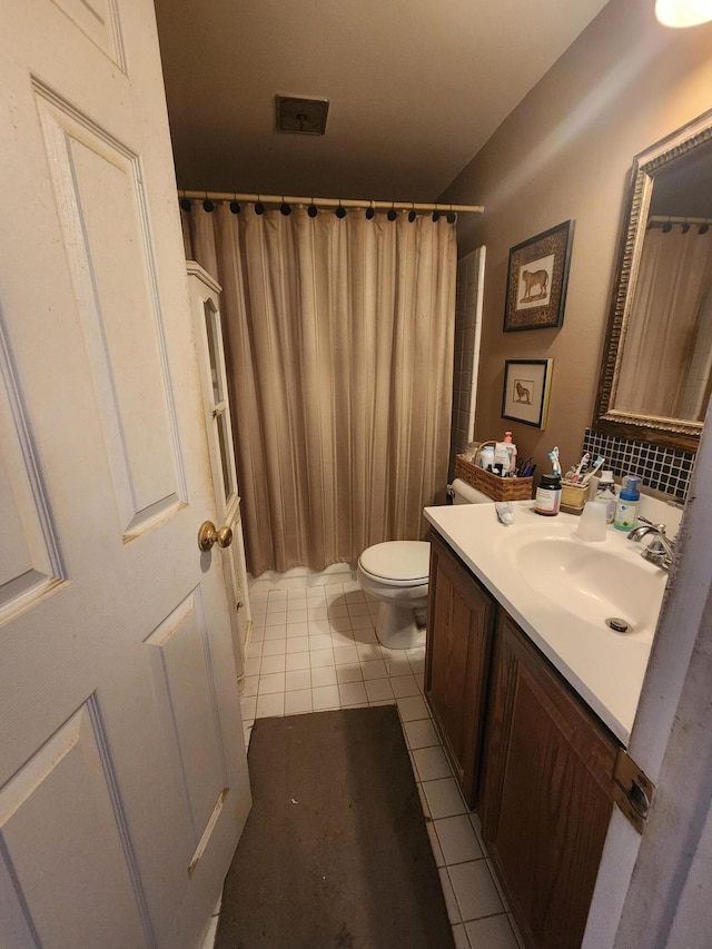 bathroom featuring walk in shower, tile patterned floors, toilet, and vanity