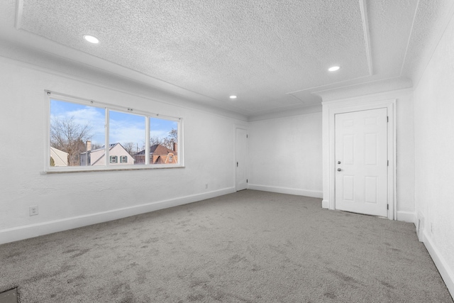 empty room with carpet flooring and a textured ceiling